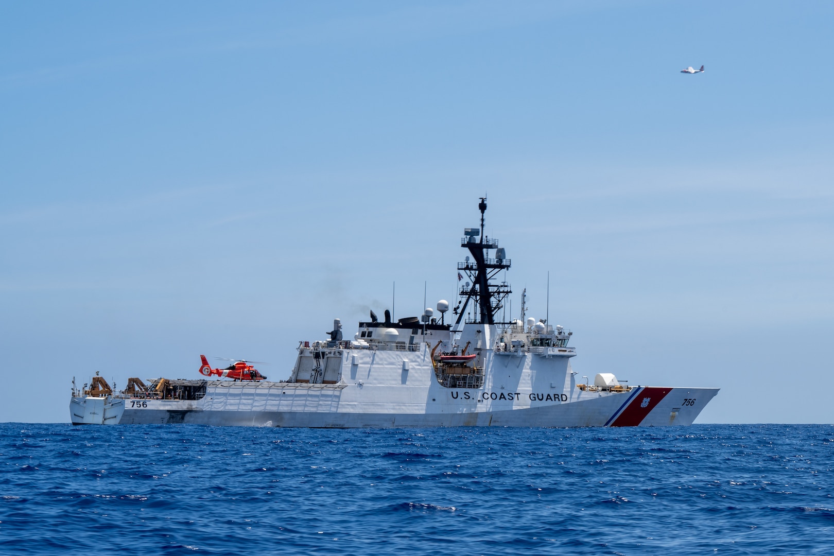 An MH-65 Dolphin helicopter assigned to Coast Guard Air Station Barbers Point lands on the flight deck of the Legend-class cutter USCGC Kimball (WMSL 756) in the Pacific Ocean, July 11, 2026.