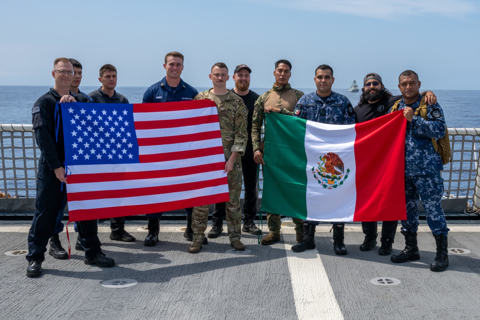 U.S. Coast Guardsmen, Mexican Naval Infantry and Mexican sailors pose with their respective country’s flags aboard U.S. Coast Guard Legend-class cutter USCGC Kimball (WMSL 756) during Exercise Rim of the Pacific 2026 in the Pacific Ocean, July 12, 2026.
