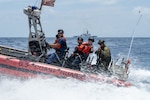 U.S. Coast Guard Chief Petty Officer Matthew Jacobs, a boatswain’s mate, drives the Legend-class cutter USCGC Kimball’s over-the-horizon small boat while Ensign Jonathan Barrett, a law enforcement officer, provides instruction to member of the Mexican Naval Infantry during pursuit training in the Pacific Ocean as part of Exercise Rim of the Pacific 2026, July 12, 2026.