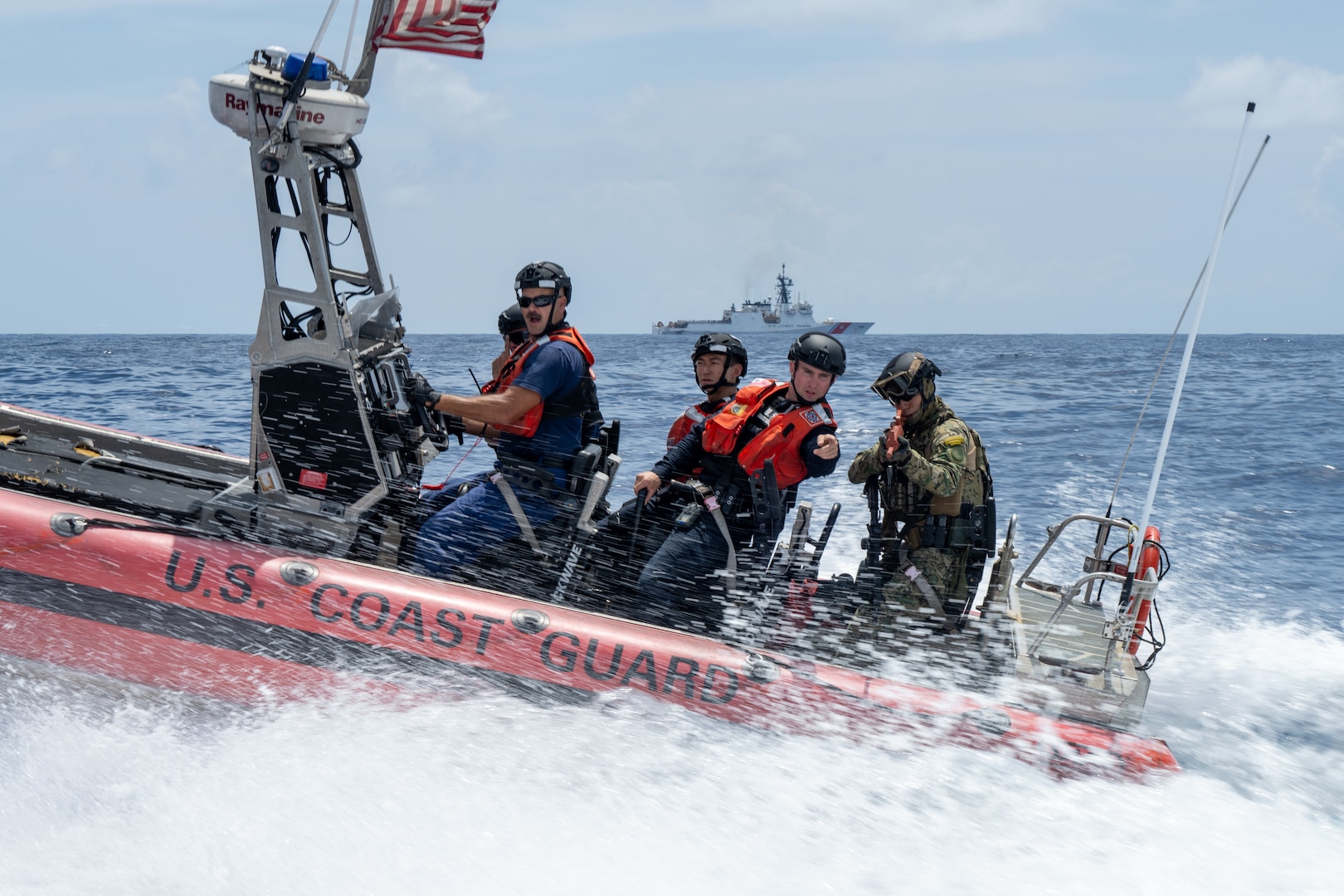 U.S. Coast Guard Chief Petty Officer Matthew Jacobs, a boatswain’s mate, drives the Legend-class cutter USCGC Kimball’s over-the-horizon small boat while Ensign Jonathan Barrett, a law enforcement officer, provides instruction to member of the Mexican Naval Infantry during pursuit training in the Pacific Ocean as part of Exercise Rim of the Pacific 2026, July 12, 2026.