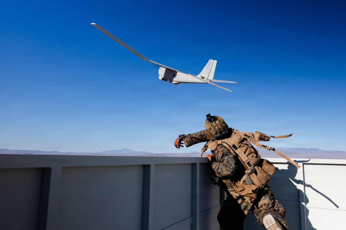 U.S. Marine Corps Cpl. Cameron Green, a New York native and a grenadier with 2nd Battalion, 1st Marine Regiment, 1st Marine Division, launches a RQ-20B Puma small unmanned aircraft during a company-level urban assault during Service Level Training Exercise 4-26 at Range 220, Marine Corps Air Ground Combat Center, Twentynine Palms, California, July 30, 2026. SLTE is a premier training event that ensures the Marine Corps remains a highly lethal, adaptable force capable of dominating the future multi-domain fight.  (U.S. Marine Corps photo by Sgt. Daniel Avilaramirez)