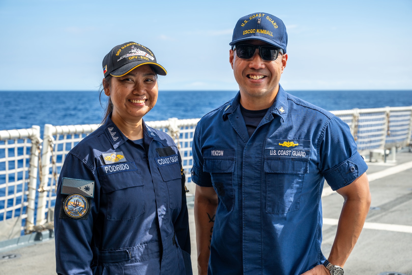 A Philippine coast guardsman and U.S. Coast Guard Chief Warrant Officer London Venzon, supply officer, laugh on the flight deck of the Legend-class U.S. Coast Guard Cutter Kimball (WMSL 756) in the Pacific Ocean, July 13, 2026.