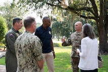 A group of people talk to each other at Joint Base Charleston, South Carolina.