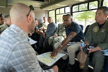 A group of people talk to each other on a surrey at Joint Base Charleston, South Carolina.