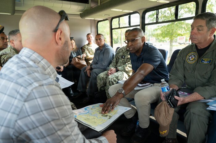 A group of people talk to each other on a surrey at Joint Base Charleston, South Carolina.