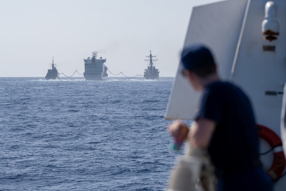 U.S. Coast Guard Petty Officer 3rd Class Darren Fell Jr., a storekeeper, looks out at a replenishment-at-sea operation from the flight deck of the U.S. Coast Guard Cutter Kimball (WMSL 756) in the Pacific Ocean, July 17, 2026.