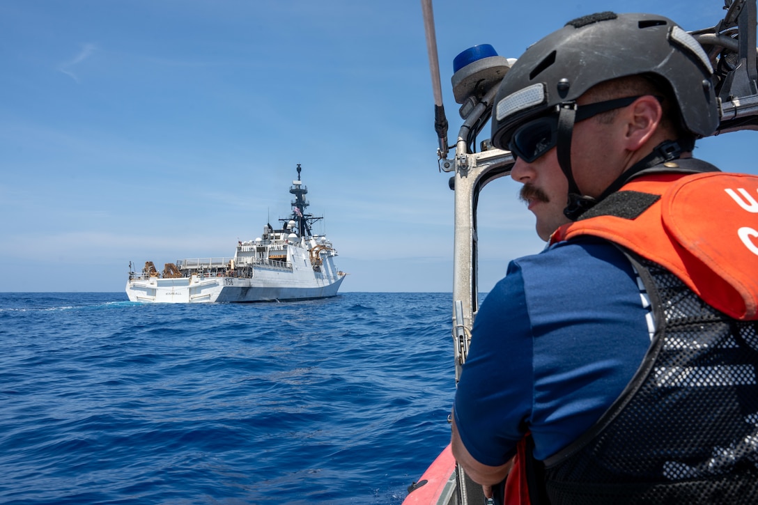 U.S. Coast Guard Petty Officer 2nd Class Kamiah Olsen, a boatswain’s mate, drives a small boat behind the Legend-class cutter USCGC Kimball (WMSL 756) in the Pacific Ocean, July 20, 2026.