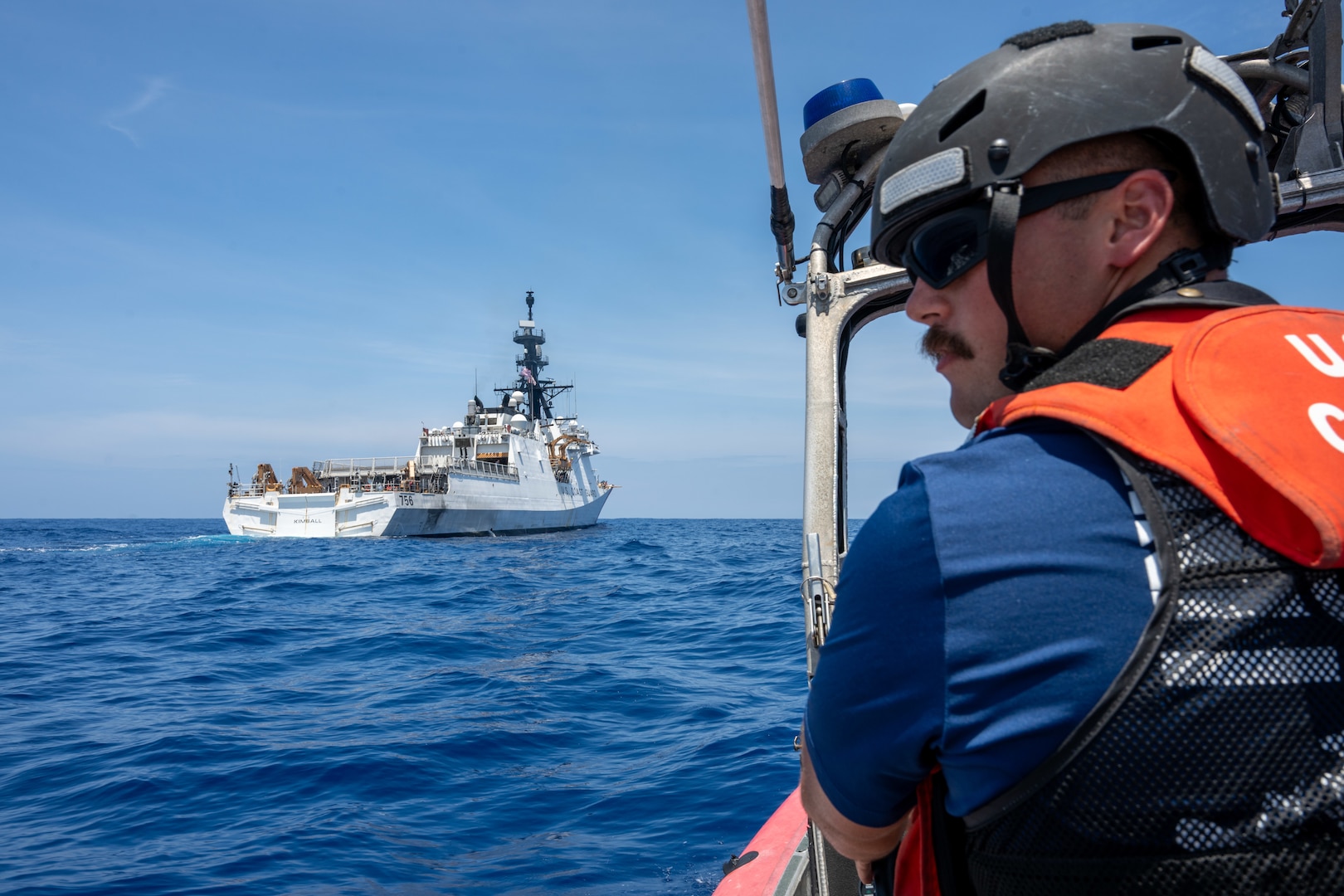 U.S. Coast Guard Petty Officer 2nd Class Kamiah Olsen, a boatswain’s mate, drives a small boat behind the Legend-class cutter USCGC Kimball (WMSL 756) in the Pacific Ocean, July 20, 2026.