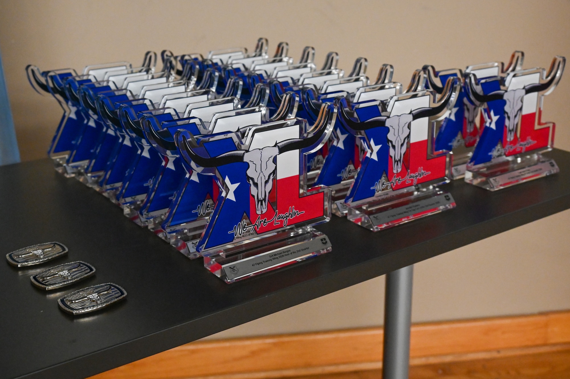 A row of trophies sits atop a table prior to the 47th Flying Training Wing (FTW) Second Quarter Awards Ceremony at Laughlin Air Force Base, Texas, July 31, 2026. The 47 FTW recognized the most outstanding performers throughout the second quarter. (U.S. Air Force photo by Airman 1st Class Kylie Rabb)