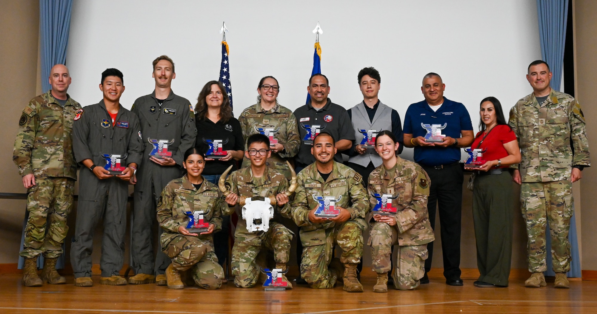The winners of the 47th Flying Training Wing (FTW) Second Quarter Awards and 47 FTW base leadership pose for a photo at Laughlin Air Force Base, Texas, July 31, 2026. 18 U.S. Air Force Airmen and civilian employees were recognized for their outstanding contributions to the instillation during the second quarter. (U.S. Air Force photo by Airman 1st Class Kylie Rabb)