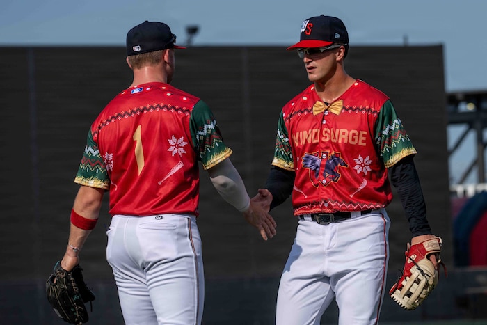 Jay Thomason, Wind Surge utility player, high fives his teammate at Equity Bank Park in Wichita, Kansas, July 25, 2026. Jay graduated from the U.S. Air Force Academy in 2024 and was drafted by the Minnesota Twins baseball organization and currently plays for their affiliate team. (U.S. Air Force photo by Airman 1st Class Tavian Sims)