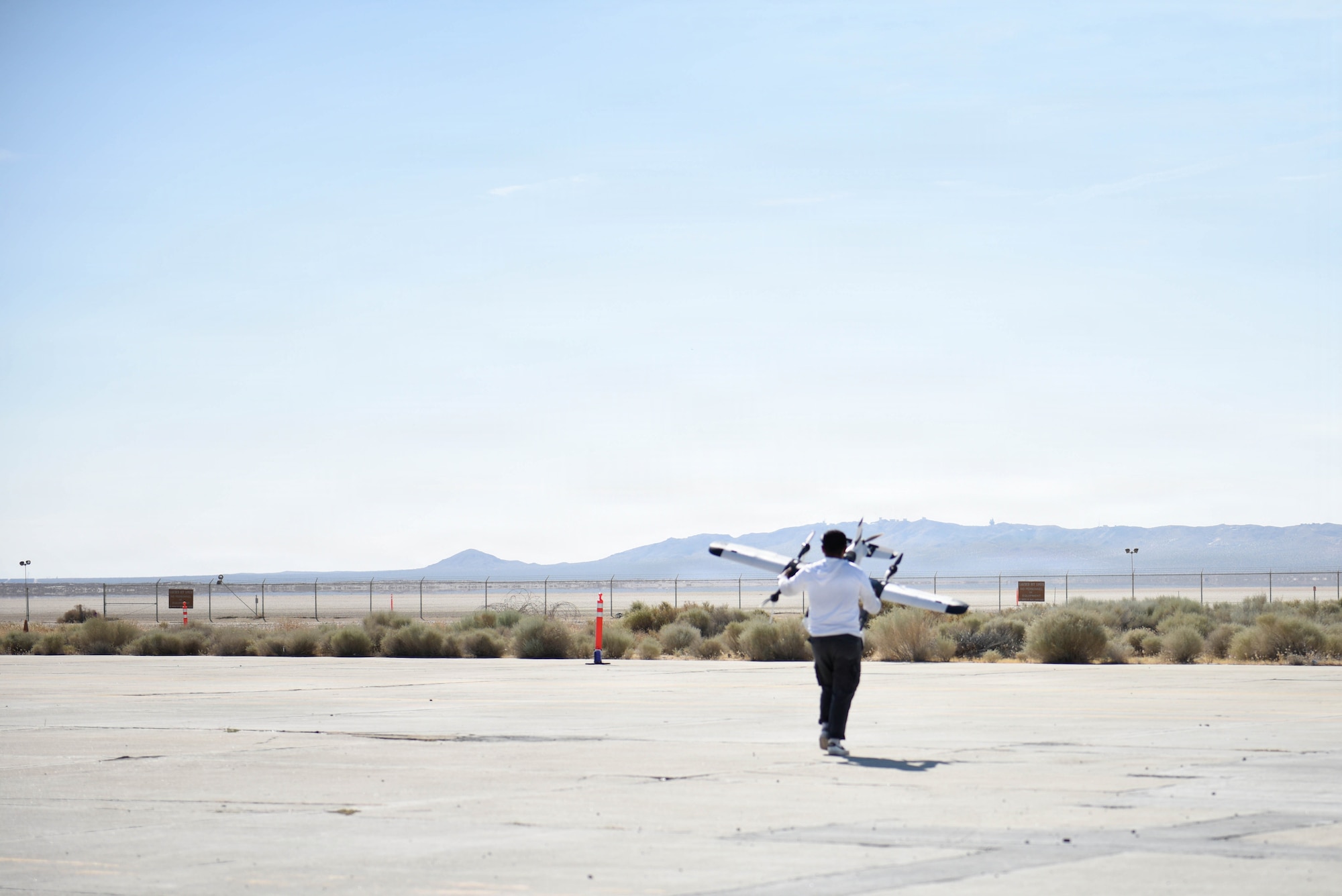 A vendor sets up a small Unmanned Aircraft Systems to test its takeoff and landing capabilities during Game of Drones at Edwards Air Force Base, Calif., July 16, 2026. GoD amplifies the Department of Wars call upon both service and industry to rapidly accelerate testing, acquisition, and production of unmanned systems for the warfighter, referred to as Drone Dominance. (U.S. Air National Guard photograph by Airman Christian Rodriguez)
