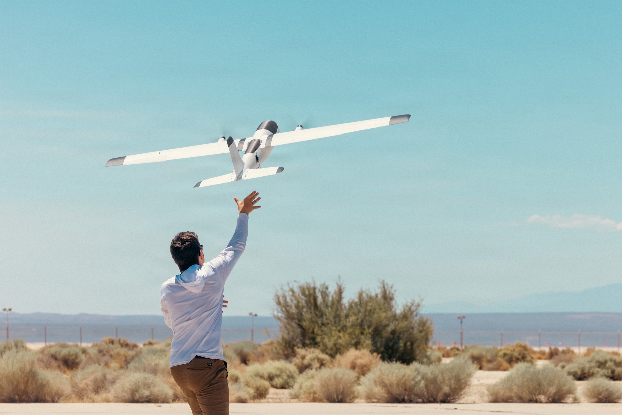 Noah Benton of Titan Dynamics launches a rapidly produced sUAS during "Game of Drones" 26-2 at Edwards Air Force Base, California on June 16, 2026. Hosted by the 412th Test Wing’s Experimental Test Force, in collaboration with the Defense Contract Management Agency’s US-X unit, the event supports the Air Force Test Center’s mission to accelerate the evaluation of autonomous technologies through collaborative experimentation and rapid user feedback. These evaluations will help accelerate placement onto the sUAS Blue List, strengthening efforts to meet the Secretary of War’s Drone Dominance initiative. (U.S. Air Force photo by Brandon Hernandez)