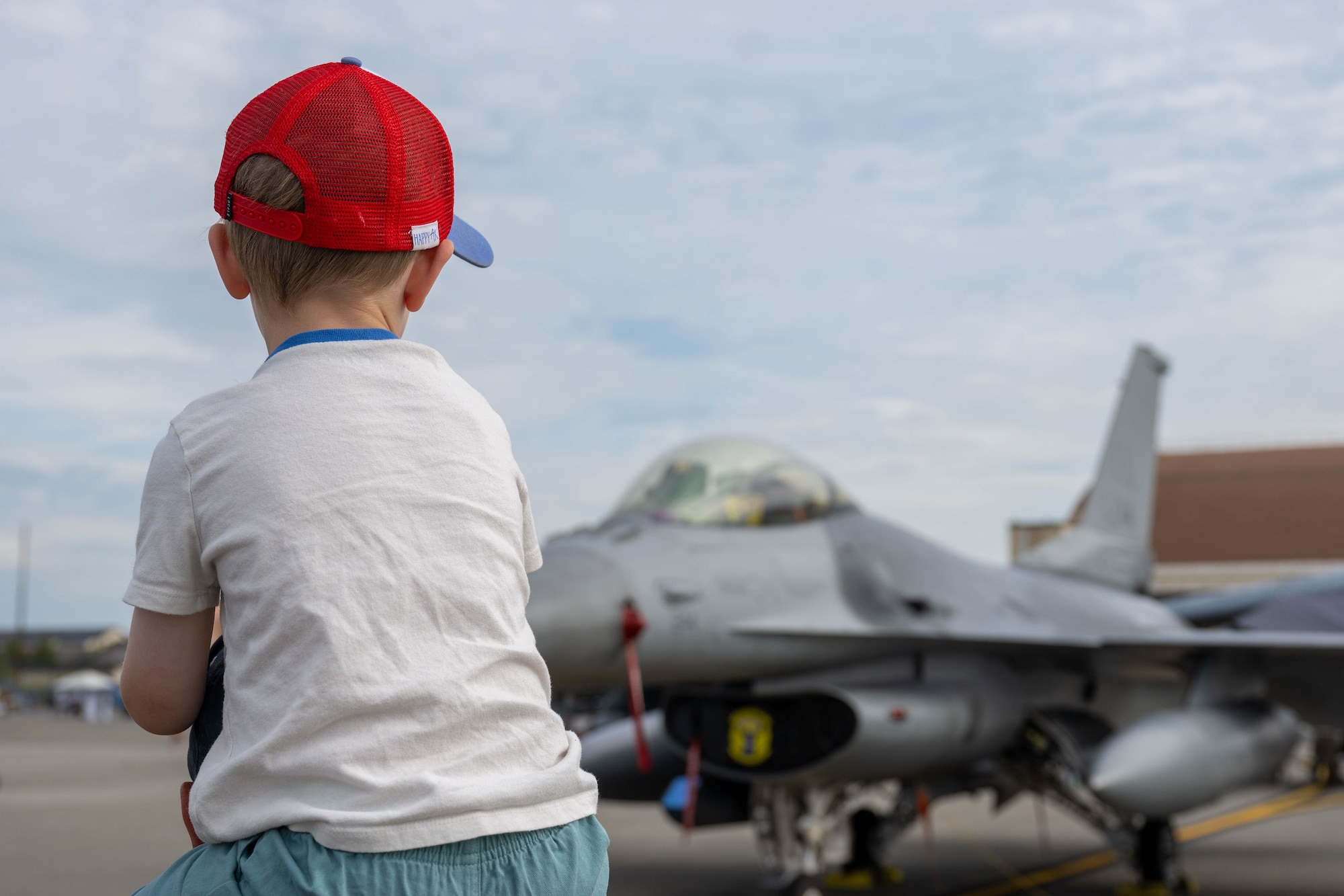 A child admires an F-16 Fighting Falcon assigned to the 18th Fighter Interceptor Squadron, during the Arctic Lightning Air Show at Eielson Air Force Base, Alaska, Aug. 2, 2026.