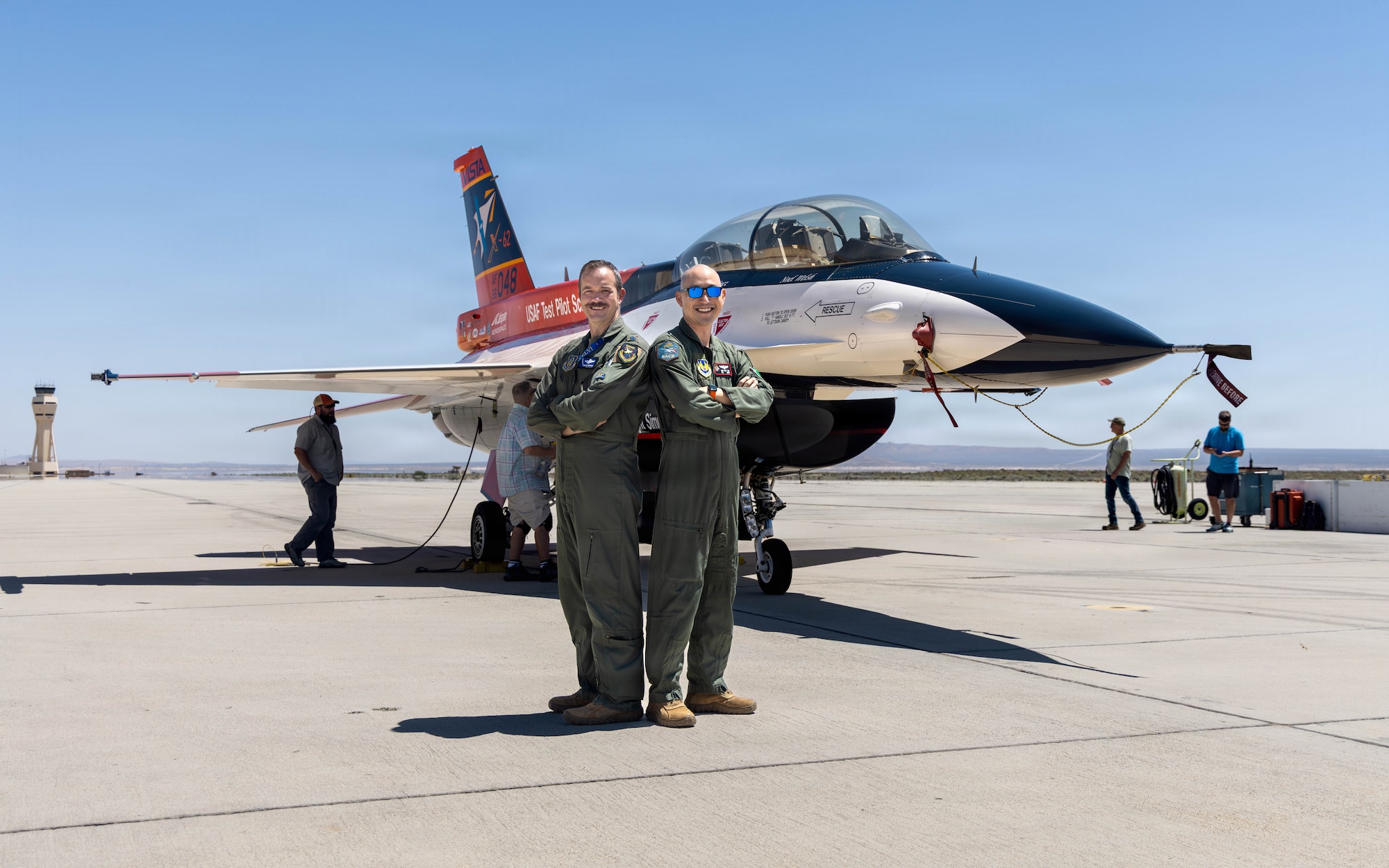 Lt. Col. Philip Downing, 370th Flight Test Squadron commander, and Wei Lee, senior flight test engineer, 418th FLTS, pose after completing a test mission for HAVE HOLIDAYS at Edwards Air Force Base, California, April 29, 2026. HAVE HOLIDAYS saw simultaneous integration and evaluation of a wide suite of modular technologies into the X-62’s Enterprise Open Mission System Architecture computer. This included the integration of a non-prime, third-party autonomous agent onto the X-62, testing of enhanced safety rules to prevent autonomous vehicles from violating user-established operational limits, and further chip integration for advanced sensor exploitation. The research is part of ongoing efforts the U.S. Air Force Test Pilot School and industry partners. (U.S. Air Force photo by Lindsey Gordon)