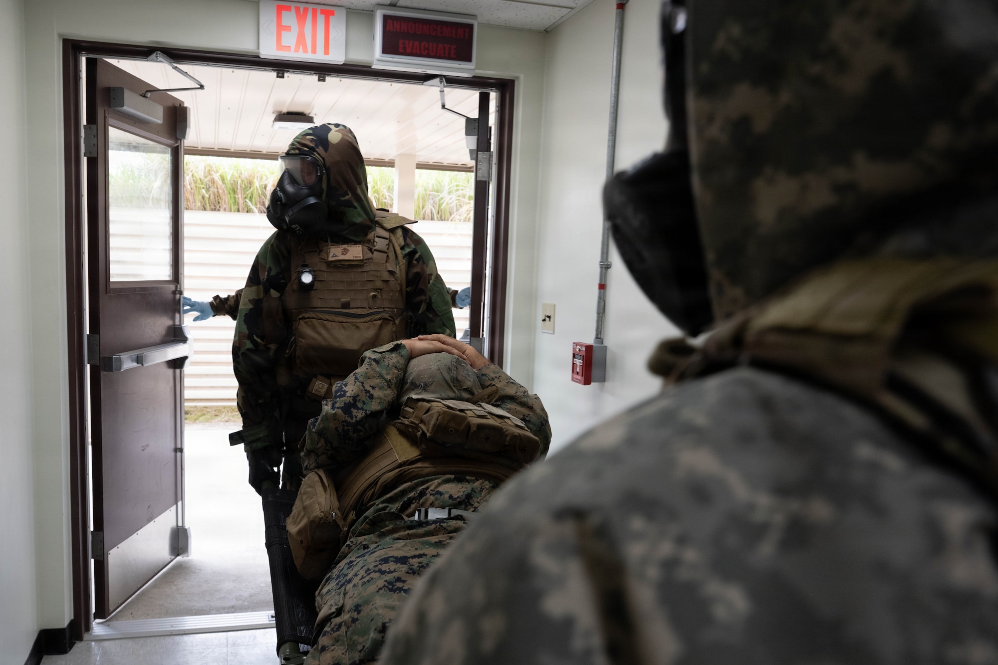 Service members carry a participant with a simulated injury.
