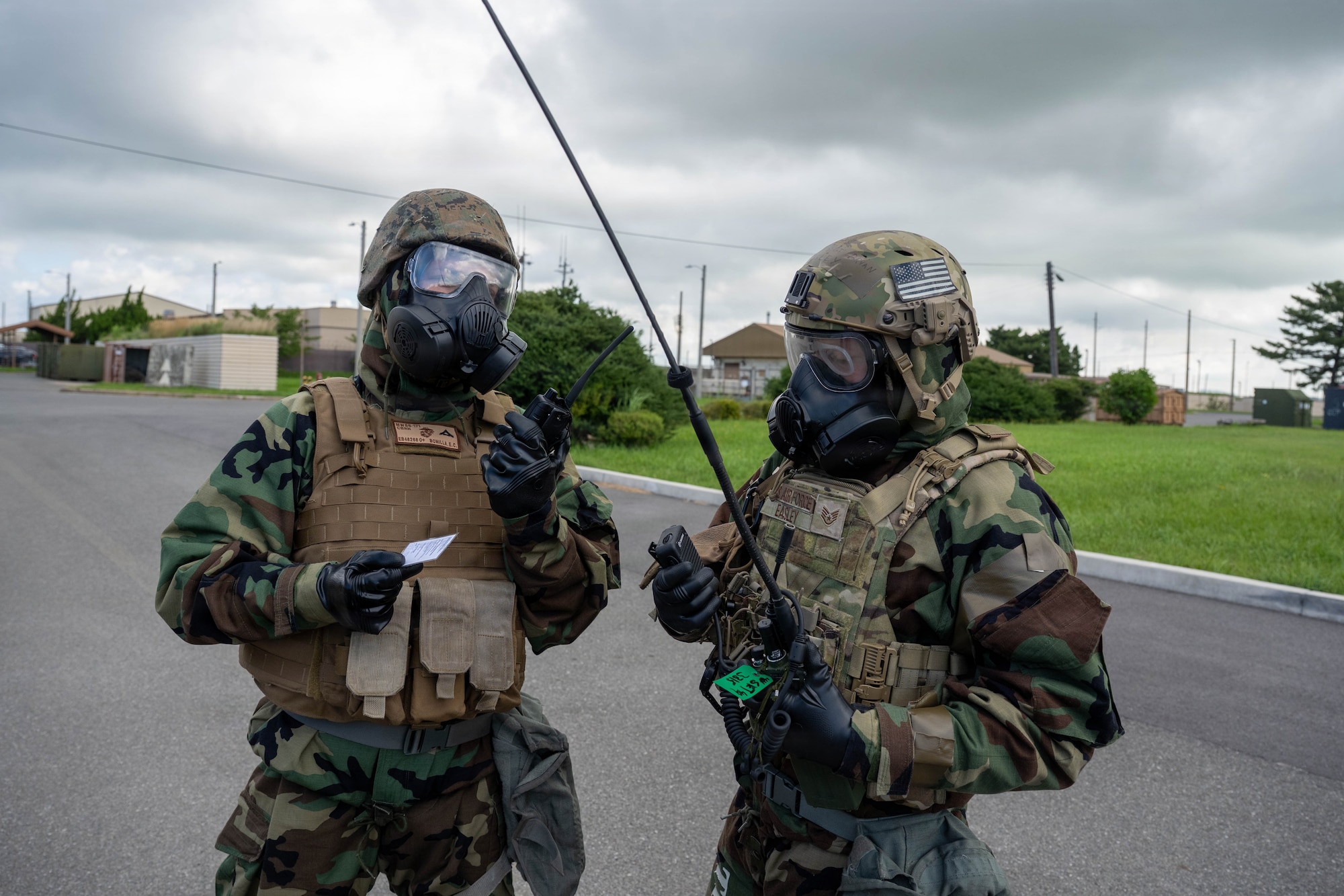 U.S. Marine and Airman use radio.
