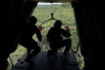 U.S. Marines with Marine Medium Tiltrotor (VMM) Squadron 262, Marine Aircraft Group 36, 1st Marine Aircraft Wing and Expeditionary Operations Training Group, III Marine Expeditionary Force lower a rescue carriage during hoist training in Okinawa, Japan, July 29, 2026.