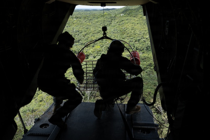 U.S. Marines with Marine Medium Tiltrotor (VMM) Squadron 262, Marine Aircraft Group 36, 1st Marine Aircraft Wing and Expeditionary Operations Training Group, III Marine Expeditionary Force lower a rescue carriage during hoist training in Okinawa, Japan, July 29, 2026.