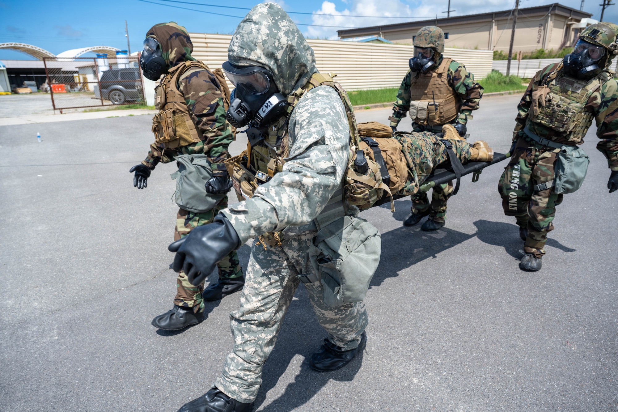 Service members carry a participant with a simulated injury.