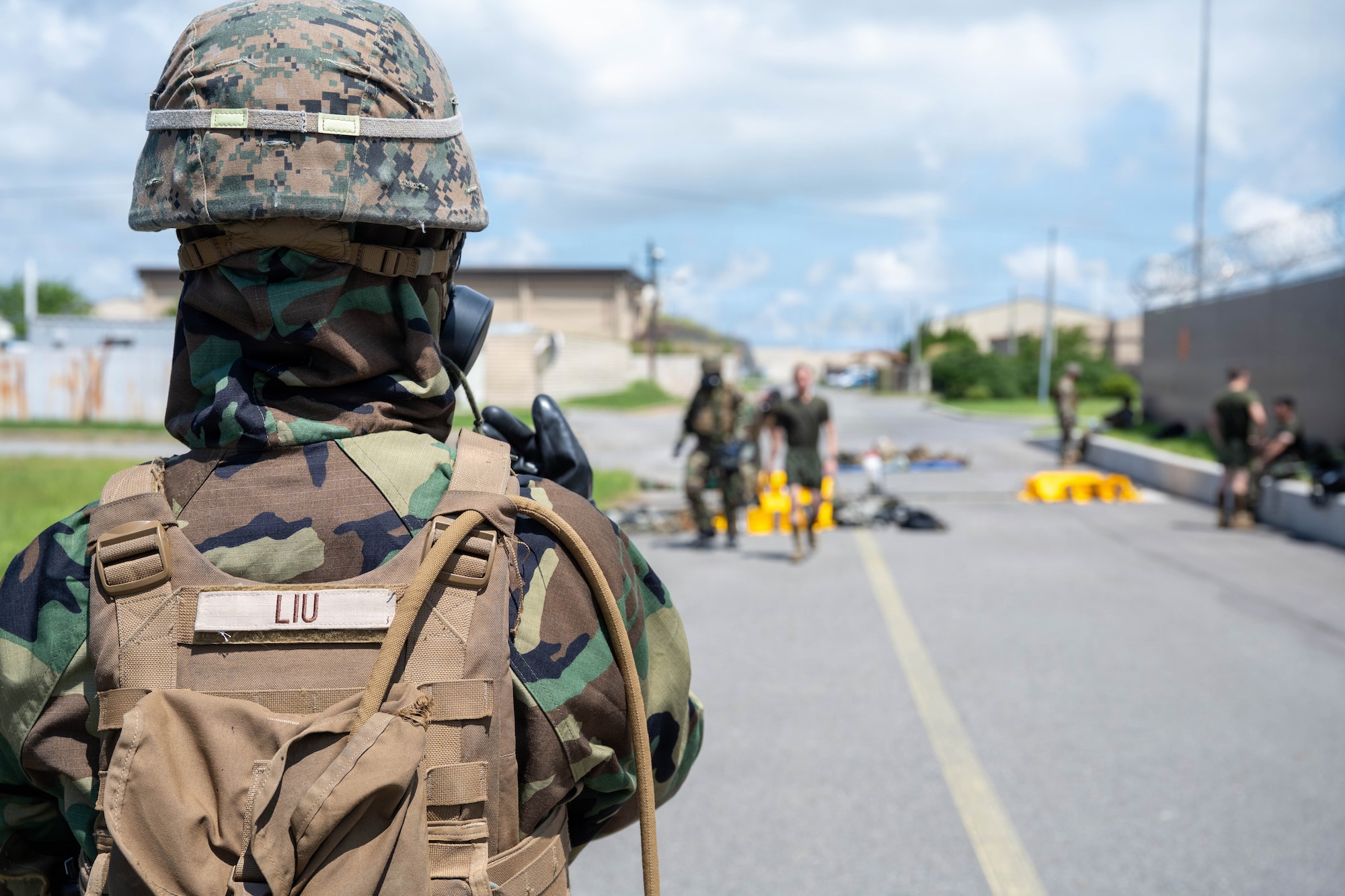 A Marine guides a training participant with verbal instructions.