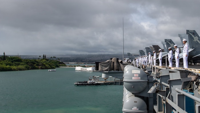 U.S. Navy Sailors, assigned to Nimitz-class aircraft carrier USS Theodore Roosevelt (CVN 71), man the rails as the ship passes the USS Arizona memorial while departing Joint Base Pearl Harbor-Hickman, Aug. 1, 2026.