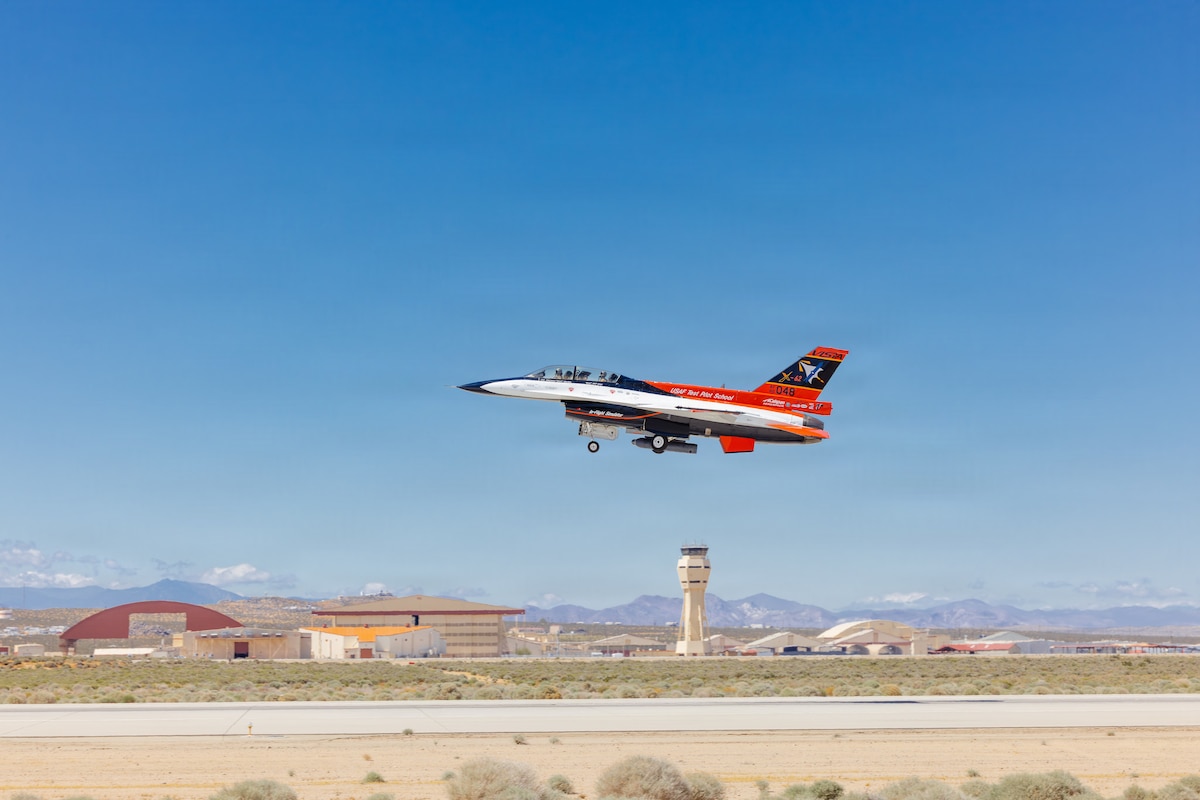 Rachel Kinard, Air Force Test Pilot School director of research, and Lt. Col. Philip Downing, 370th Flight Test Squadron commander, depart for a HAVE HEAT test mission at Edwards Air Force Base, California, April 16, 2026. Leveraging Lockheed Martin’s Infrared Search and Track Legion Pod, during the HAVE HEAT program, the X-62 VISTA platform demonstrated the ability of AI agents to ingest live infrared sensor data, directing the X-62 to autonomously intercept an airborne target in real time. (U.S. Air Force photo by Lindsey Iniguez)
