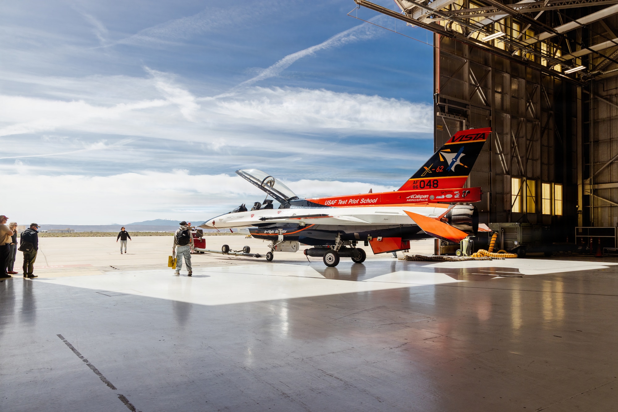 A Calspan Corporation crew tow out the X-62 VISTA ahead of multiple test flights supporting HAVE HEAT and HAVE HOLIDAYS for the Air Force Test Pilot School and industry partners at Edwards Air Force Base, California, April 22, 2026. (U.S. Air Force photo by Lindsey Iniguez).