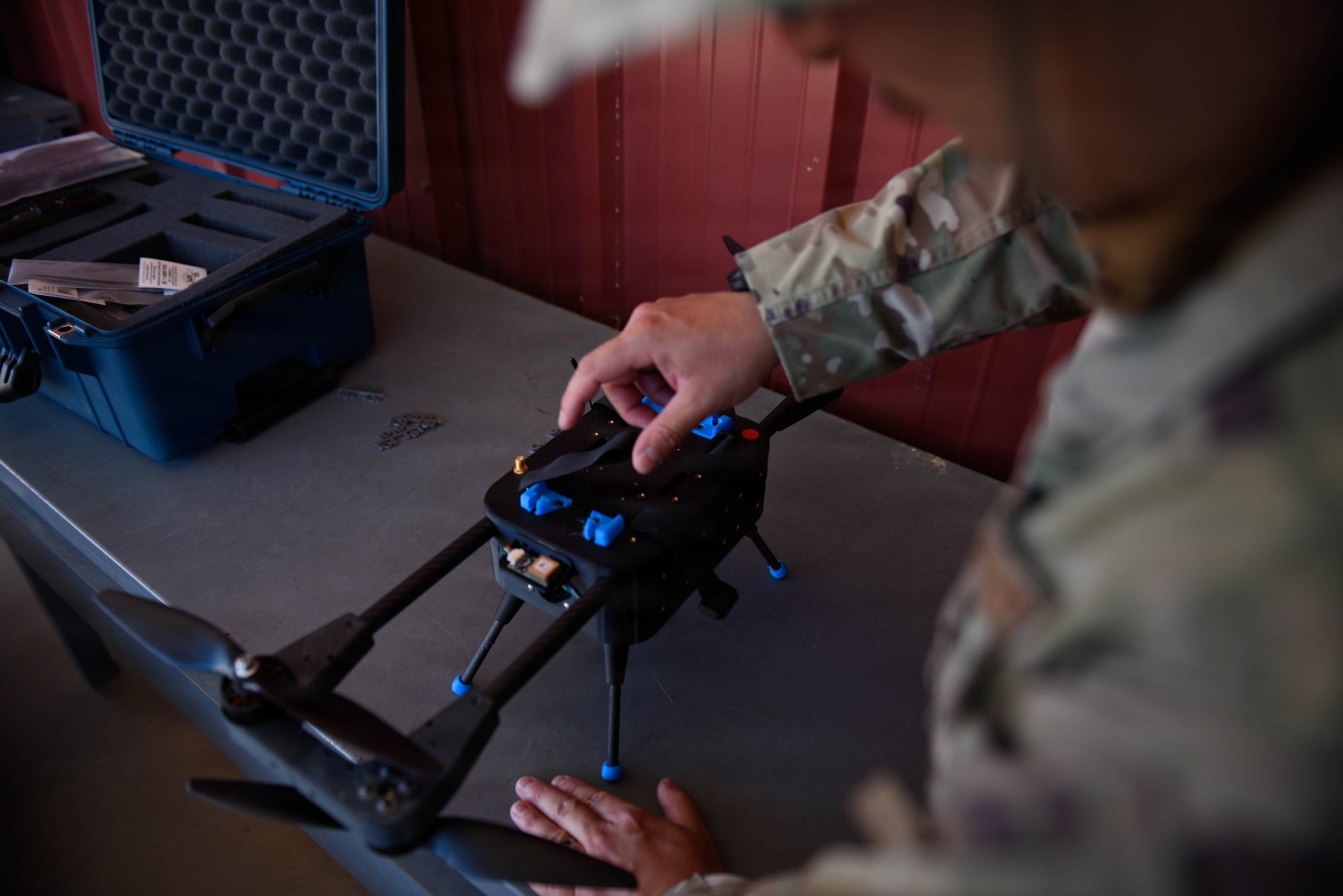 An Airman from March Air Reserve Base, gets hands on experience with a small Unmanned Aircraft Systems at Game of Drones, Edwards Air Force Base, Calif. , July 15, 2026. GoD is a week-long event bringing together industry partners, military members, and engineers to conduct live experimentation of emerging sUAS and associated hardware. GoD amplifies the Department of Wars  called upon both service and industry to rapidly accelerate testing, acquisition, and production of unmanned systems for the warfighter, referred to as Drone Dominance. (U.S. Air National Guard photograph by Airman Christian Rodriguez)