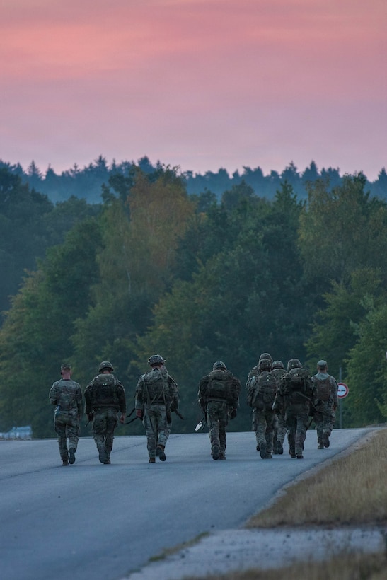 U.S. Soldiers, with the 2nd Signal Brigade, ruck 12 miles during the U.S. Army Europe and Africa (USAREUR-AF) Best Squad Competition at Grafenwoehr Training Area, Germany,  Aug. 2, 2026. Teams across U.S. Army Europe and Africa meet at Grafenwoehr Training Area, Germany, to compete for the title of Best Squad, July 30-August 6, 2026. The event tests the squad’s effectiveness, communication, and overall cohesion, as well as the individual Soldier’s technical and tactical proficiency, endurance, and fortitude. This competitive training event exercises a full range of squad-level skills, highlighting professional excellence and knowledge to determine the command’s top teams. Winners of this competition will advance to represent U.S. Army Europe and Africa at the Army Best Squad Competition. (U.S. Army Reserve photo by Sgt. Addison Shinn)