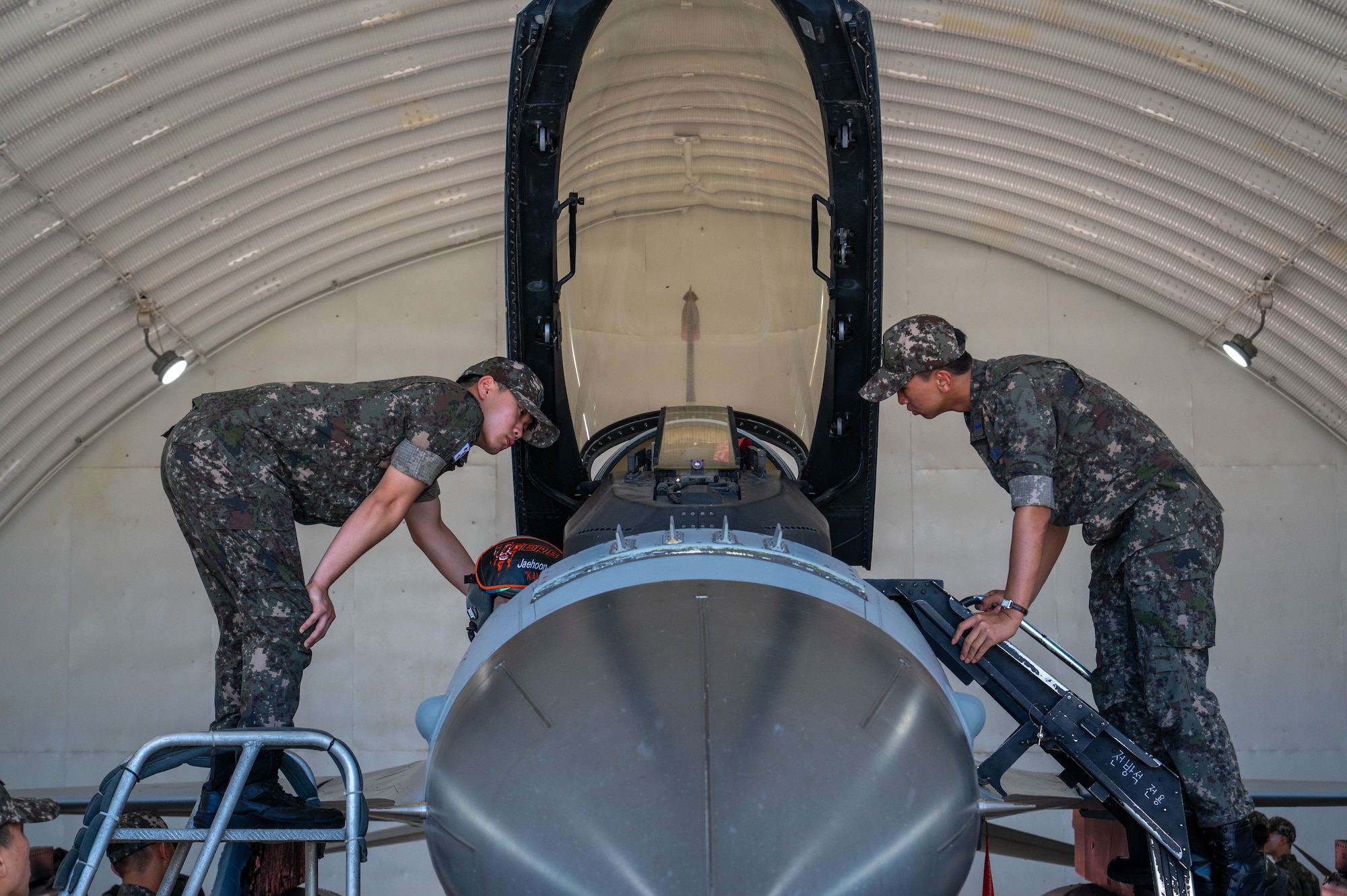 Republic of Korea Air Force Academy cadets examine a ROKAF F-16 Fighting Falcon assigned to the ROKAF 35th Fighter Group during a tour of Kunsan Air Base, ROK, July 30, 2026. ROKAF Academy cadets were invited to Kunsan AB to gain insight on the mission, interoperability and joint capabilities between the U.S. and ROK alliance and to tour base facilities and assets. (U.S. Air Force photo by Staff Sgt. Cedrique Oldaker)