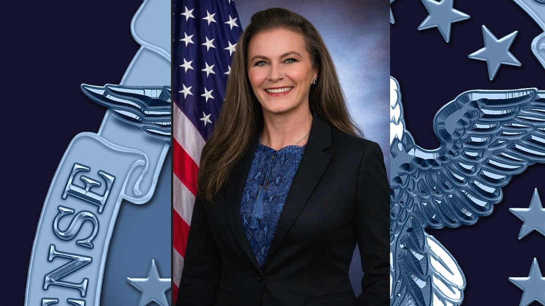 A woman posing in front of a flag.