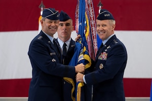 U.S. Air Force Lt. Gen. Daniel H. Tulley accepts the Air Mobility Command guidon from Air Force Chief of Staff Gen. Ken Wilsbach during the AMC Assumption of Command ceremony on Scott Air Force Base, Illinois, August 3, 2026. Tulley assumed command of AMC, leading nearly 107,000 Total Force Airmen and more than 1,100 aircraft dedicated to delivering Rapid Global Mobility that enables the Joint Force to rapidly deploy, sustain and maneuver combat power across the globe. (U.S. Air Force photo by Tech. Sgt. Dalton Williams)