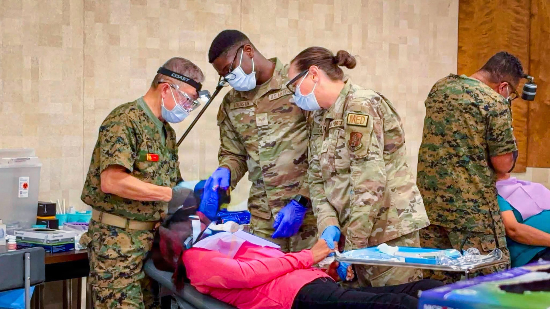 A U.S. Marine Corps dentist, assisted by two U.S. Air Force medical personnel, provides dental care to a local resident during an Innovative Readiness Training mission in the Corpus Christi and Robstown, Texas, area, July 21, 2026.