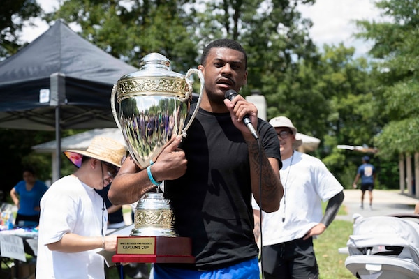 Personnel Specialist 2nd Class Kevin Armstrong assigned to Navy Medicine Readiness and Training Command Bethesda, speaks on behalf of Team four aka Purple Team who won the 2026 NMRTC Bethesda Captain’s Cup at Walter Reed National Military Medical Center, July 31, 2026. NMRTC Bethesda's mission is to maximize warfighter performance through optimized medical readiness tailored to operational requirements, enhance the readiness of the medical force to sustain expeditionary medical capability, and train and develop the Navy Medicine Force. (U.S. Navy photo by Mass Communication Specialist 2nd Class Alec Kramer)