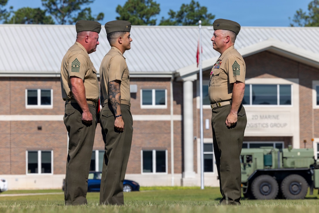 U.S. Marine Corps Master Gunnery Sgt. Bryan Cortestorres, right, a transportation chief with Headquarters and Service Battalion, 2nd Marine Logistics Group, stands at attention during his retirement ceremony at Marine Corps Base Camp Lejeune, North Carolina, July 31, 2026. Cortestorres, an Illinois native, retired after 30 years of dedicated and faithful service to the U.S. Marine Corps. (U.S. Marine Corps photo by Lance Cpl. Isabella Ramos)