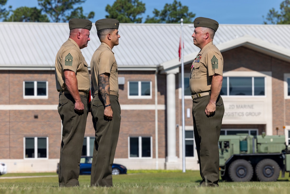 U.S. Marine Corps Master Gunnery Sgt. Bryan Cortestorres, right, a transportation chief with Headquarters and Service Battalion, 2nd Marine Logistics Group, stands at attention during his retirement ceremony at Marine Corps Base Camp Lejeune, North Carolina, July 31, 2026. Cortestorres, an Illinois native, retired after 30 years of dedicated and faithful service to the U.S. Marine Corps. (U.S. Marine Corps photo by Lance Cpl. Isabella Ramos)