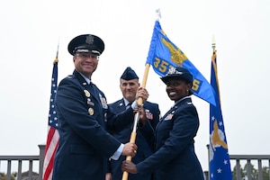U.S. Air Force Col. Sean “Metro” Fellows, 376th Recruiting Group commander, Robins Air Force Base, Georgia, passes command guideon to U.S. Air Force Maj. Fiona Pham, 353d Recruiting Squadron commander, March Air Reserve Base, California, during the 353 RCS Assumption of Command ceremony, July 29, 2026, U.S. Army Garrison Presidio of Monterey, California. Pham now commands 107 military and civilian personnel, 66 recruiting offices, 15 Military Entrance Processing Stations, and has an area of operation of the entire West Coast, which includes Arizona, California, Hawaii, Nevada, New Mexico, Utah, Idaho, Oregon, Washington, Alaska, and portions of Texas, Wyoming, and Montana, as well as, Reserve recruiting efforts in the Pacific: Anderson Air Force Base, Guam, Kadena Air Base, Japan, Misawa AB, Japan, Yokota AB, Japan, Osan AB, South Korea, and Kunsan AB, South Korea. (U.S. Air Force photo by Master Sgt. Della Creech)