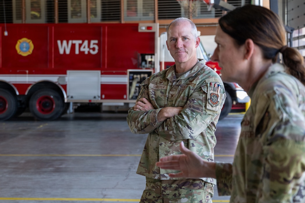 Commander listens to the command chief delivering remarks.