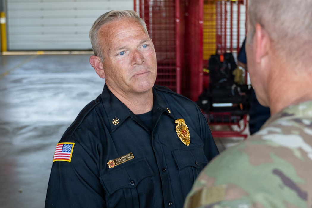 Airman receives a coin from the commander.