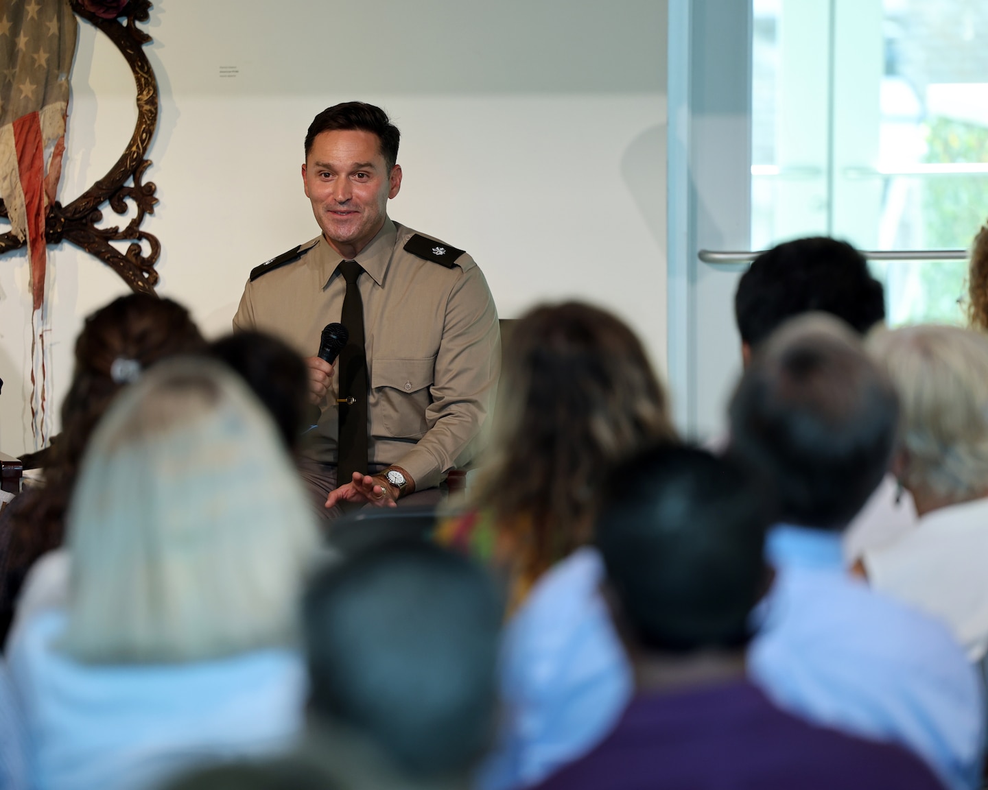 Military man talks to a group of people