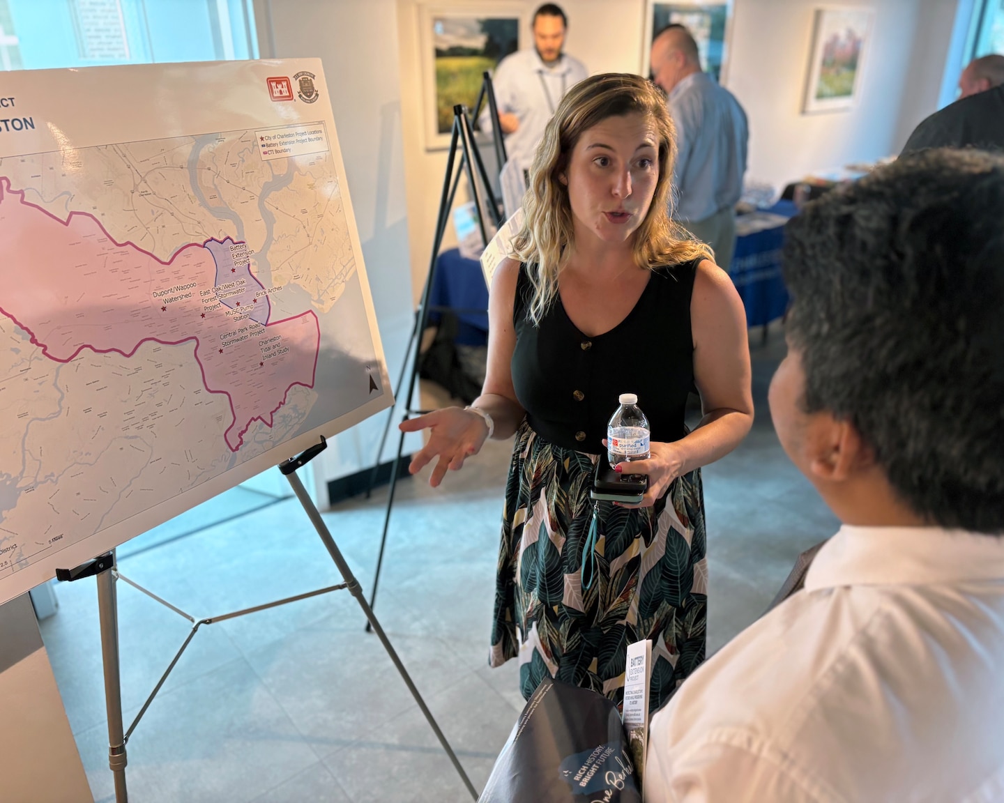 Woman discusses flooding on a map with a another person