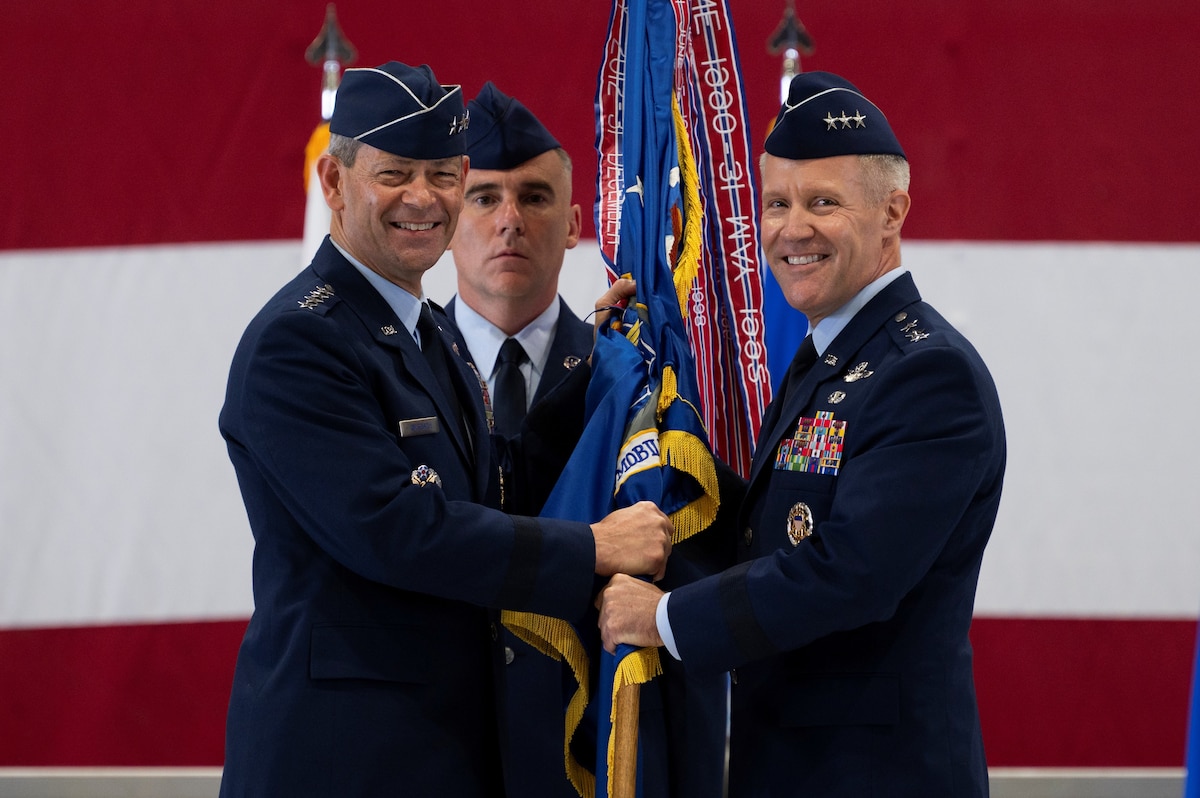 U.S. Air Force Lt. Gen. Daniel H. Tulley accepts the Air Mobility Command guidon from Air Force Chief of Staff Gen. Ken Wilsbach during the AMC Assumption of Command ceremony on Scott Air Force Base, Illinois, August 3, 2026. Tulley assumed command of AMC, leading nearly 107,000 Total Force Airmen and more than 1,100 aircraft dedicated to delivering Rapid Global Mobility that enables the Joint Force to rapidly deploy, sustain and maneuver combat power across the globe. (U.S. Air Force photo by Tech. Sgt. Dalton Williams)