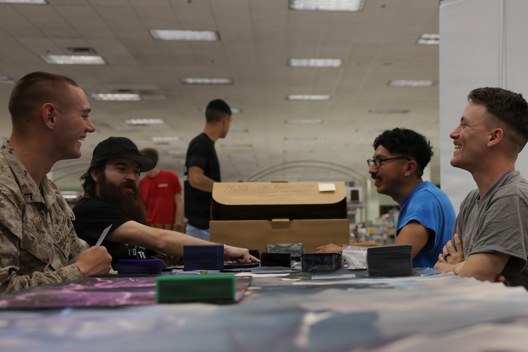 U.S. Marines at the Combat Center, take part in a card game at Mojave Game Con 2026, Marine Corps Air Ground Combat Center, Twentynine Palms, California, July 11, 2026. Mojave Game Con 2026 was hosted to create a fun and recreational game themed event for service members and families aboard the Combat Center. (U.S. Marine Corps photo by Lance Cpl. Grant Gatlin)