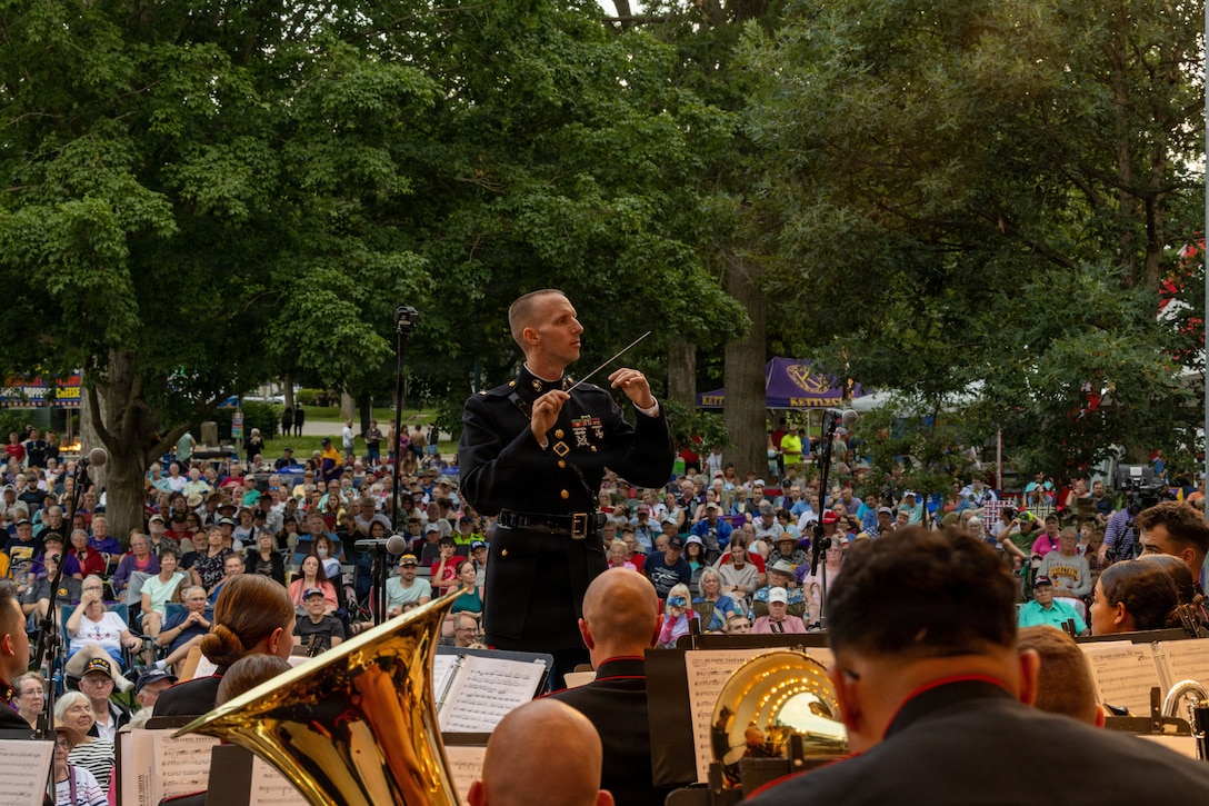 U.S. Marine Corps Chief Warrant Officer 2 John Geary, from Alaska, a band officer with 2nd Marine Aircraft Wing Band, conducts the band during the 49th Annual Sturgis Falls Celebration at Cedar Falls, Iowa June 27, 2026. The 2nd MAW Band took part in the celebration to strengthen community relations and reaffirm the history, customs, and traditions representative of the Marine Corps. (U.S. Marine Corp photo by Pfc. Keani Guthmueller)