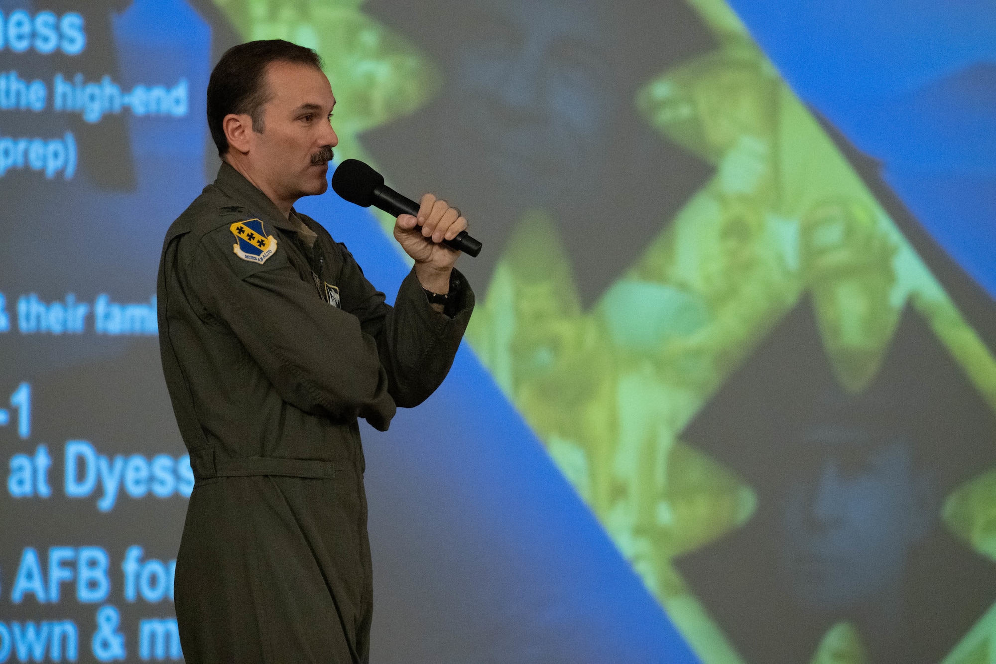 Commander holds microphone.