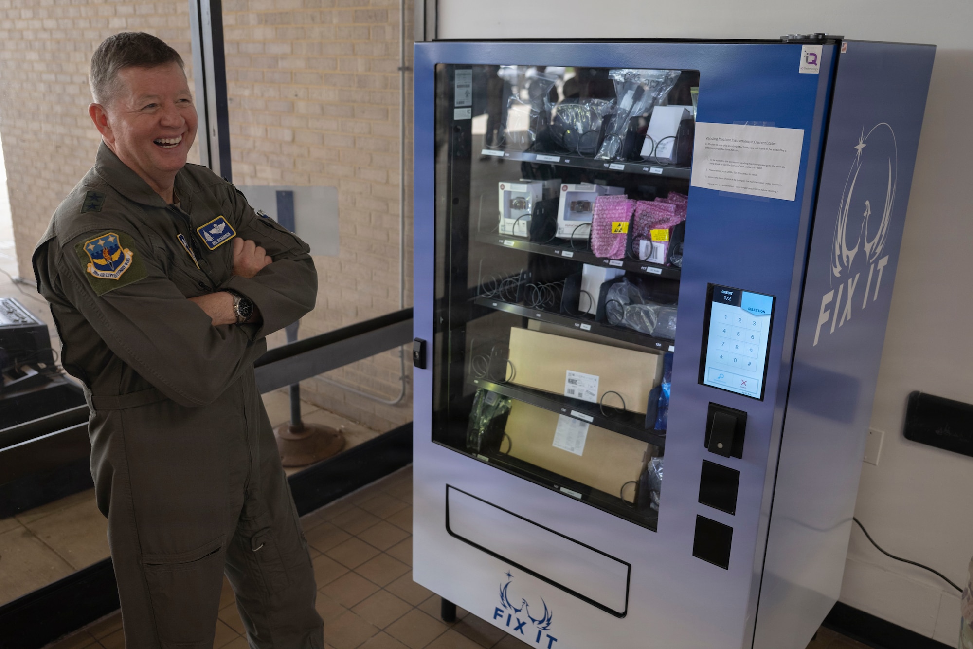 Man smiling next to a machine.