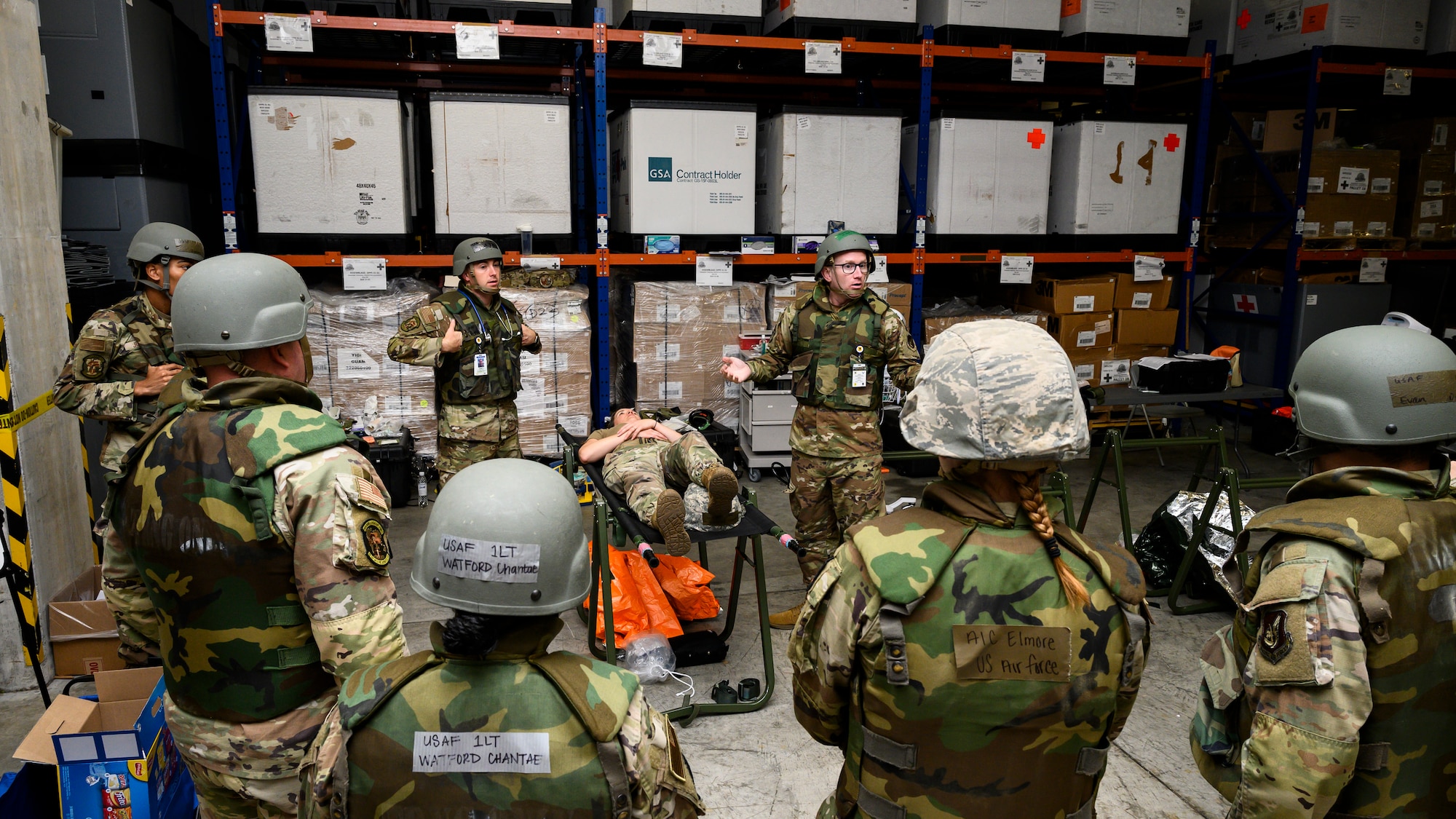 U.S. Air Force Airmen assigned to the 18th Medical Group receive a Tactical Combat Casualty Care and first aid brief before participating in an En-Route Patient Staging System exercise during Beverly Beach 26-1 at Kadena Air Base, Japan, Aug. 4, 2026. The exercise evaluated the 18th MDG's ability to rapidly establish expeditionary medical capabilities and prepare patients for aeromedical evacuation during contingency operations. (U.S. Air Force photo by Airman 1st Class Francisco Huerta)