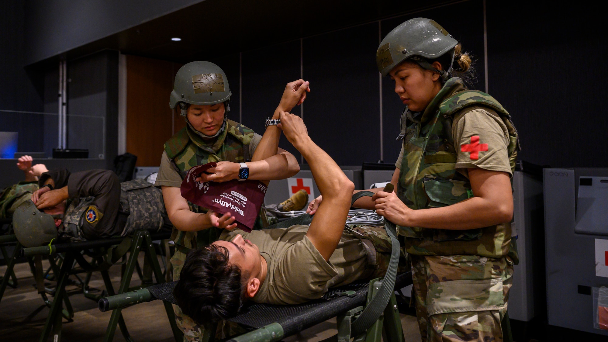 U.S. Air Force Capt. Manami Jones, left, and Capt. Saidel Sunga, 18th Medical Group clinical nurses, monitor simulated patients inside an En-Route Patient Staging System facility before aeromedical evacuation during Beverly Beach 26-1 at Kadena Air Base, Japan, Aug. 4, 2026. The exercise tested the 18th MDG’s ability to rapidly receive, stabilize and prepare patients for aeromedical evacuation during contingency operations. (U.S. Air Force photo by Airman 1st Class Francisco Huerta)