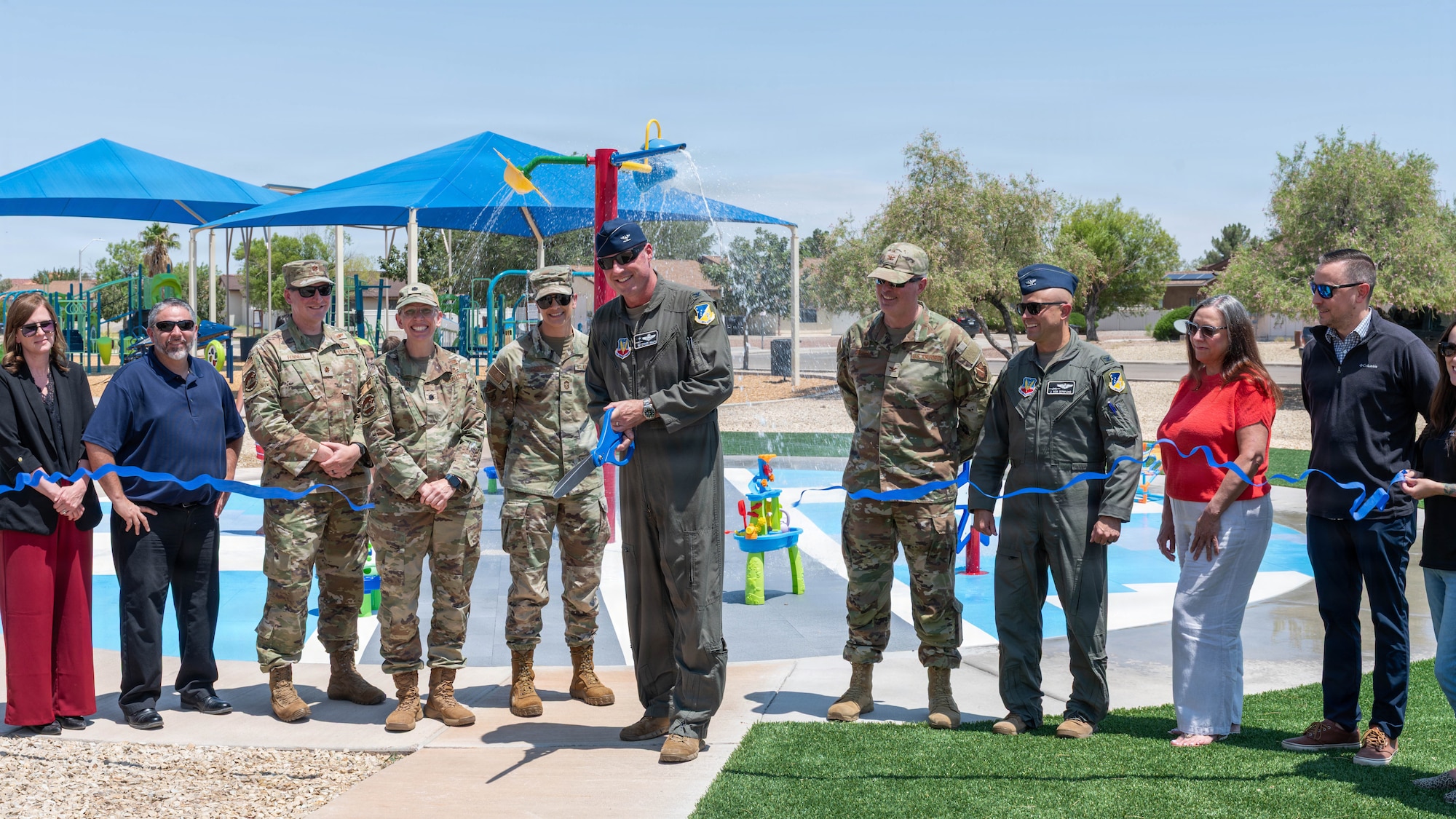 U.S. Air Force Col. Michael Mullin, 49th Wing commander, cuts a ribbon at the splash pad ribbon-cutting celebration at Holloman Air Force Base, New Mexico, July 8, 2026.